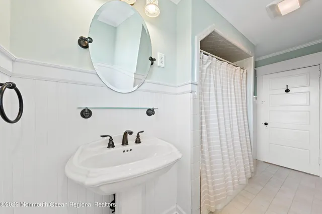 a bathroom with a sink a mirror and shower