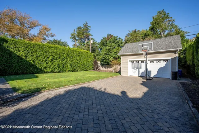 a view of a house with a yard and garage