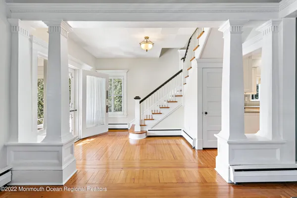 a view of an entryway with wooden floor