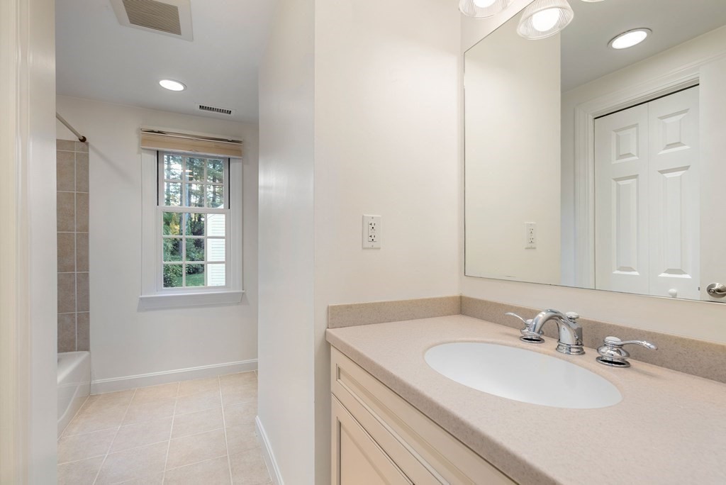 79 Jericho Road, Unit 79 Weston, MA 02493 - Photo 12 of 16 a bathroom with a sink double vanity and a mirror
