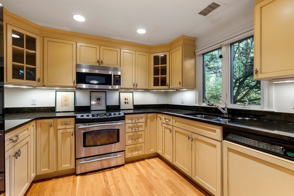 79 Jericho Road, Unit 79 Weston, MA 02493 - Photo 3 of 16 a kitchen with stainless steel appliances granite countertop a stove a sink and a microwave