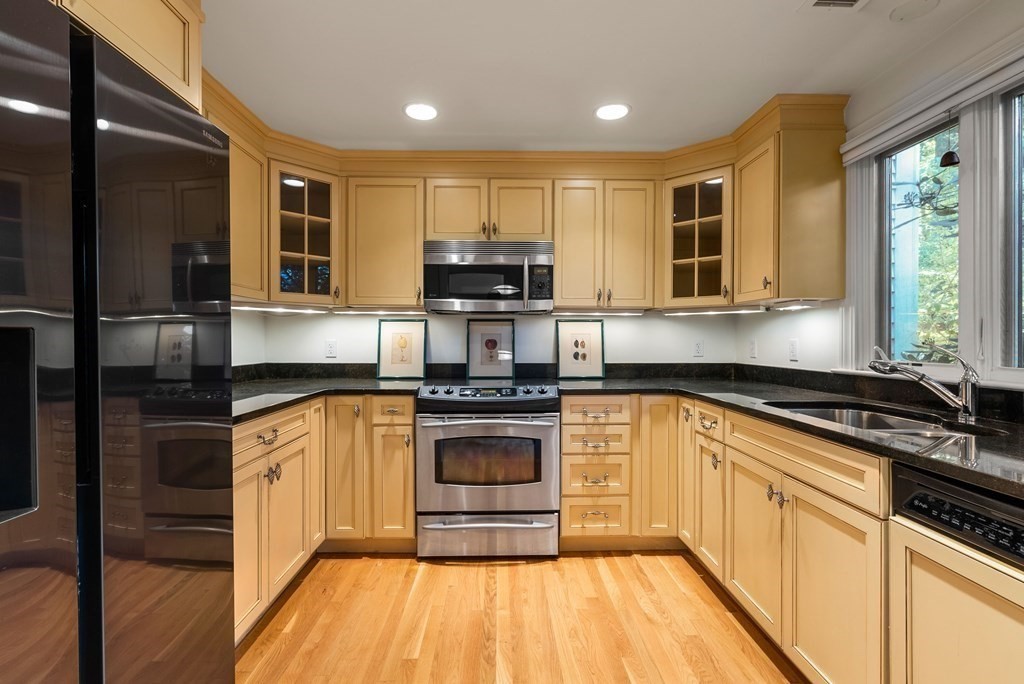 79 Jericho Road, Unit 79 Weston, MA 02493 - Photo 4 of 16 a kitchen with stainless steel appliances granite countertop a stove a sink and a refrigerator