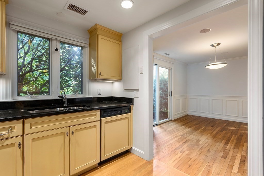 79 Jericho Road, Unit 79 Weston, MA 02493 - Photo 5 of 16 a kitchen with granite countertop white cabinets and a window