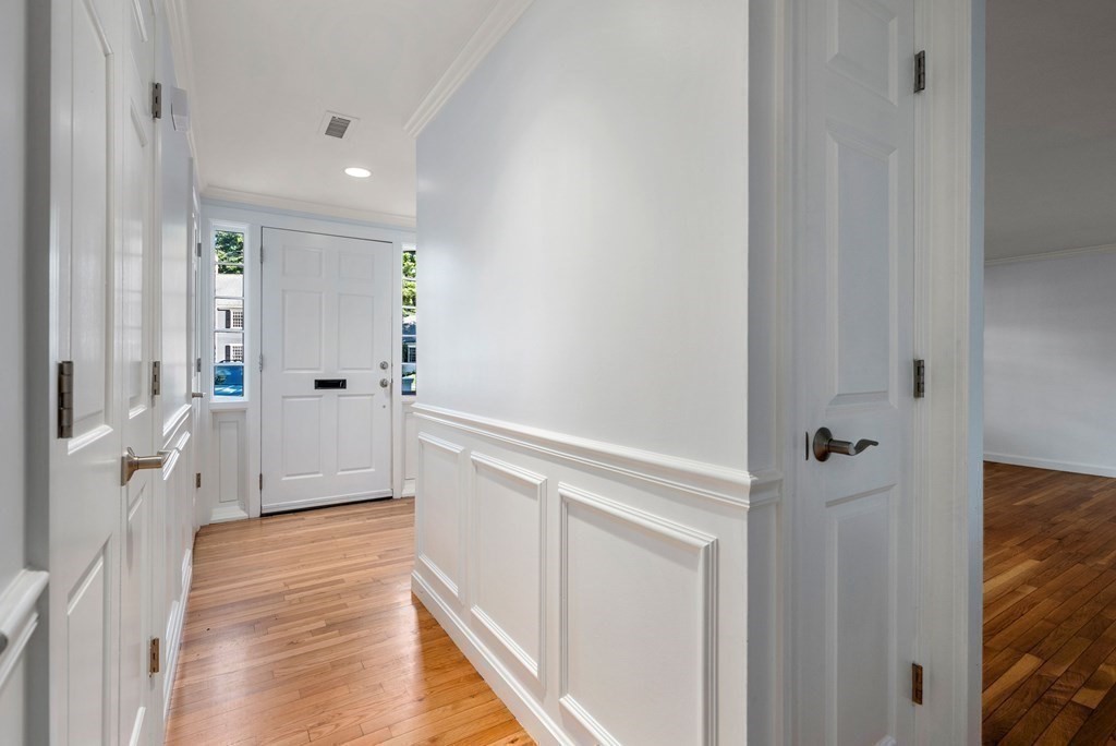 79 Jericho Road, Unit 79 Weston, MA 02493 - Photo 8 of 16 a view of a hallway with wooden floor and staircase