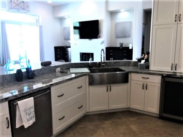 a kitchen with stainless steel appliances granite countertop a sink and a stove