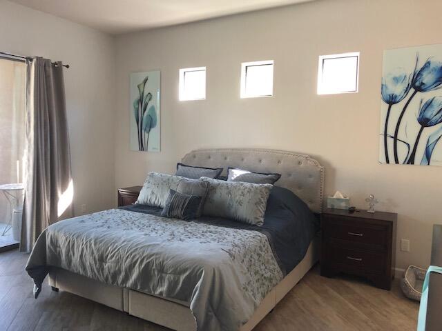 74130 Pele Place Palm Desert, CA 92211 - Photo 8 of 19 a bed sitting in a bedroom next to a window and a flat screen tv