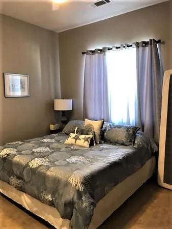 a bedroom with a bed and a window