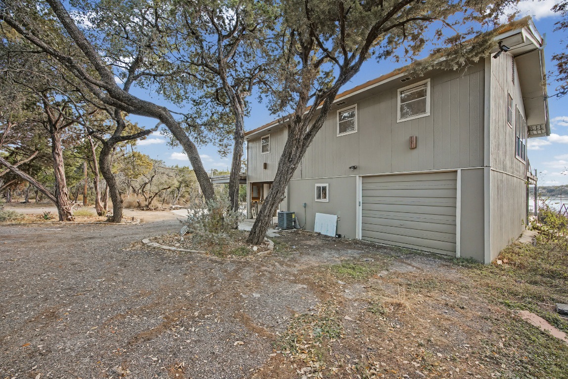 17019 Rocky Ridge Road Austin, TX 78734 - Photo 20 of 37 a view of a house with a large tree