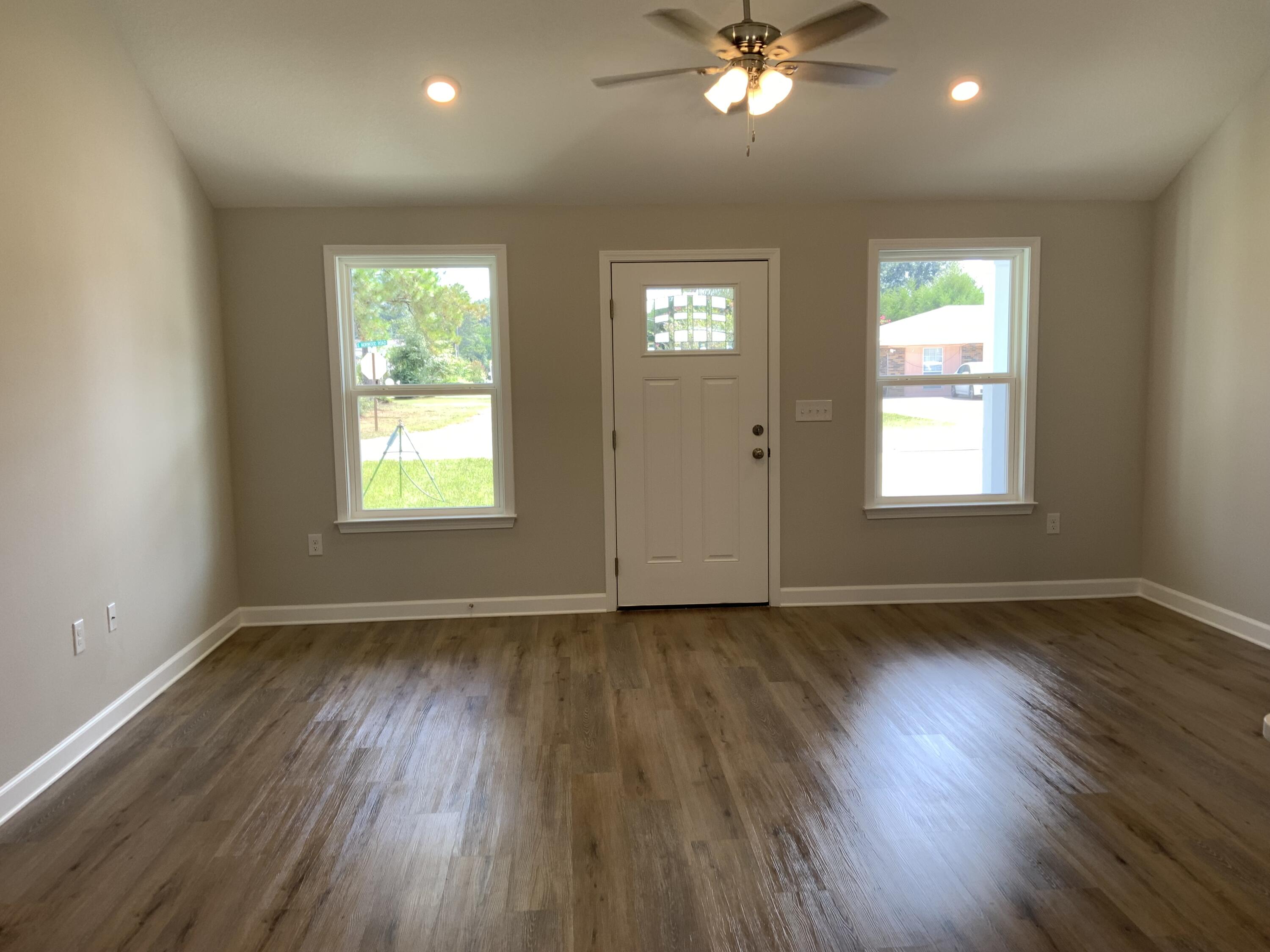 200 South Norwood Road DeFuniak Springs, FL 32435 - Photo 2 of 7 a view of an empty room with wooden floor and a window