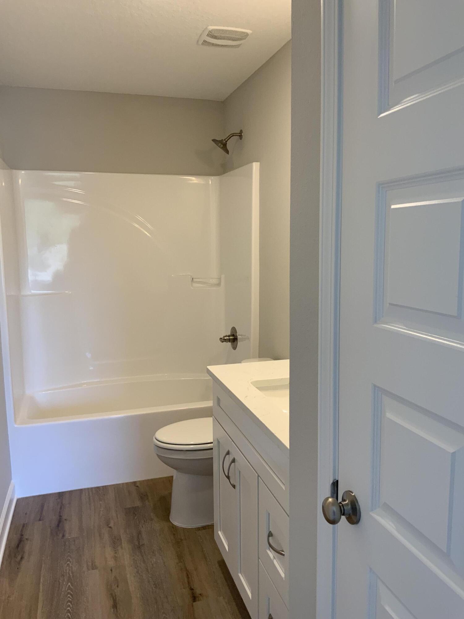 200 South Norwood Road DeFuniak Springs, FL 32435 - Photo 6 of 7 a bathroom with a sink a toilet and shower