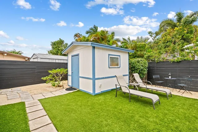 a view of a house with backyard porch and sitting area