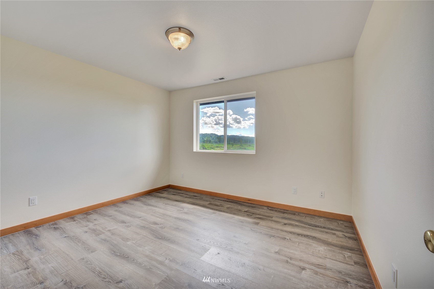 12112 Roosevelt Road Snohomish, WA 98290 - Photo 20 of 36 an empty room with wooden floor and windows
