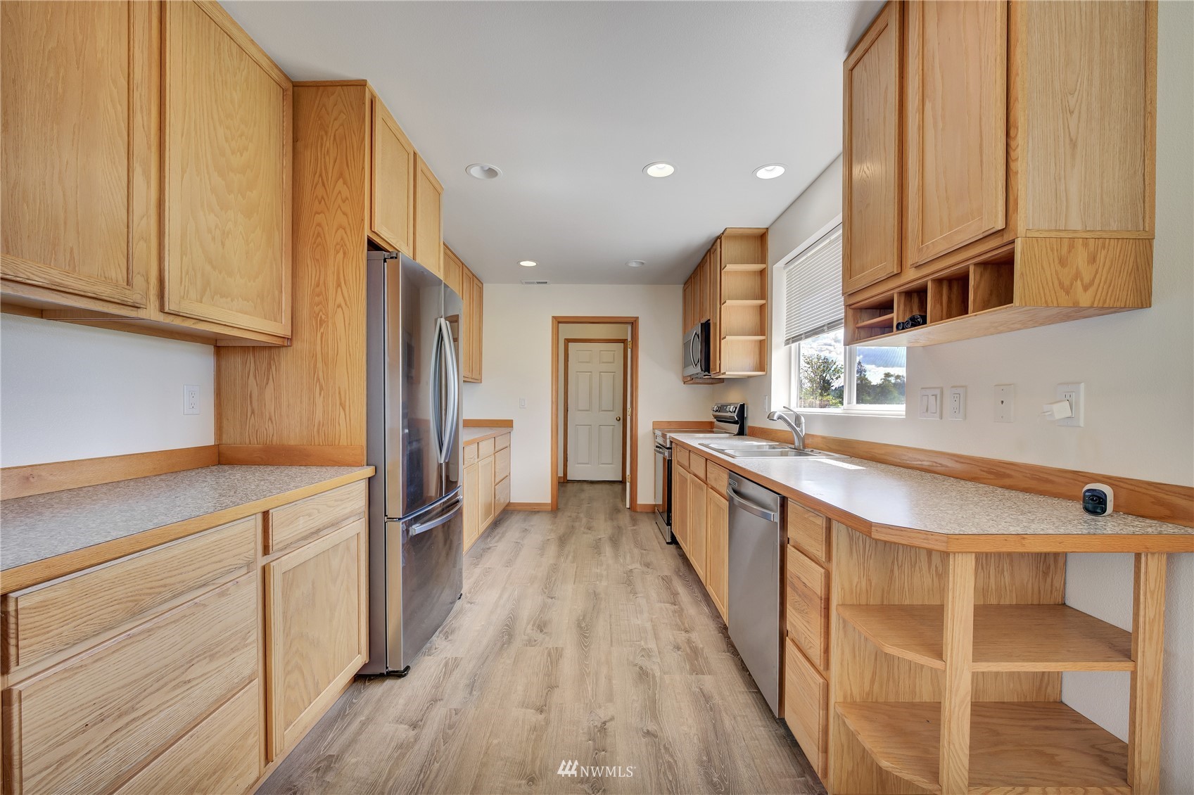 12112 Roosevelt Road Snohomish, WA 98290 - Photo 26 of 36 a kitchen with stainless steel appliances granite countertop a sink and wooden cabinets