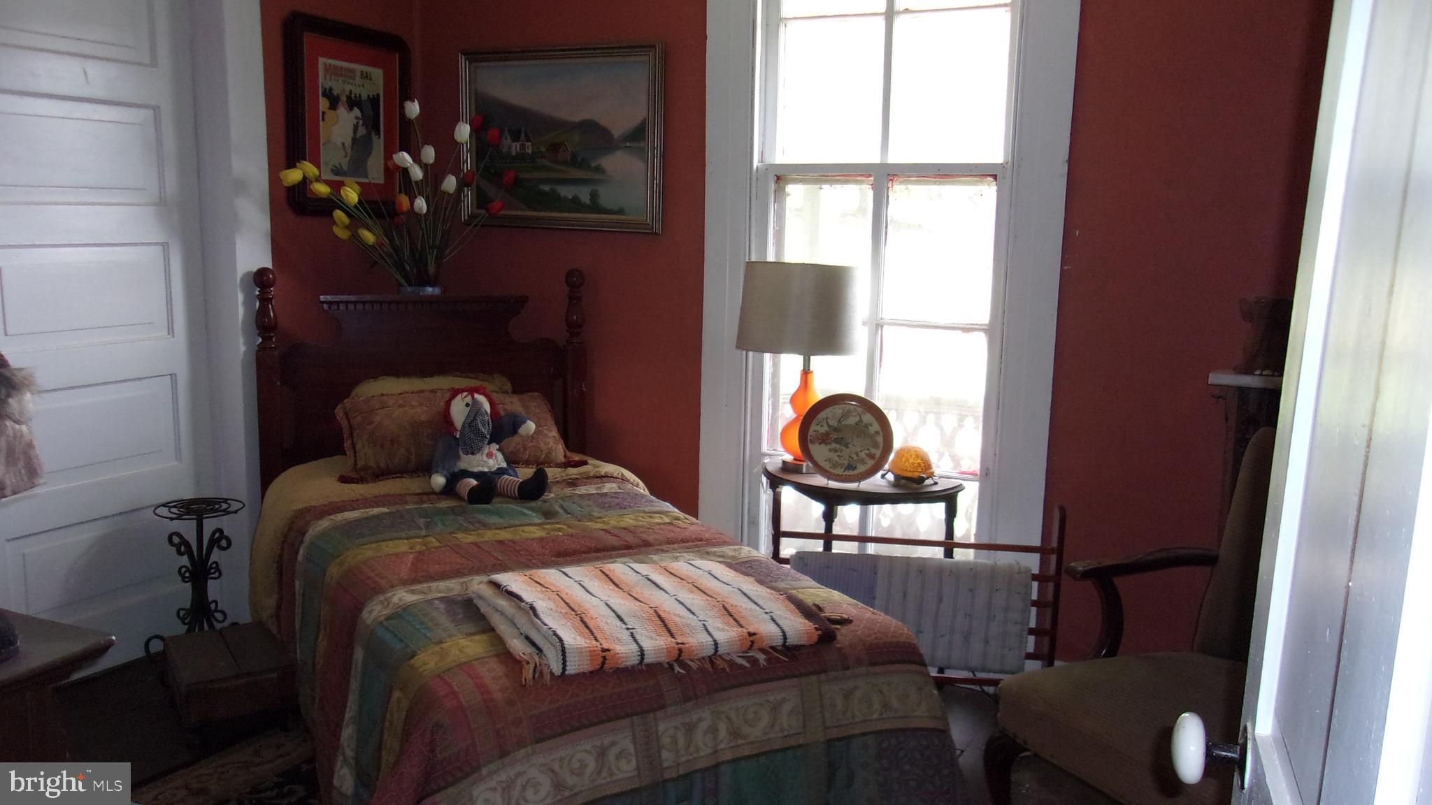 108 Knight Street Bloomington, MD 21523 - Photo 30 of 31 a bed sitting in a bedroom next to a window