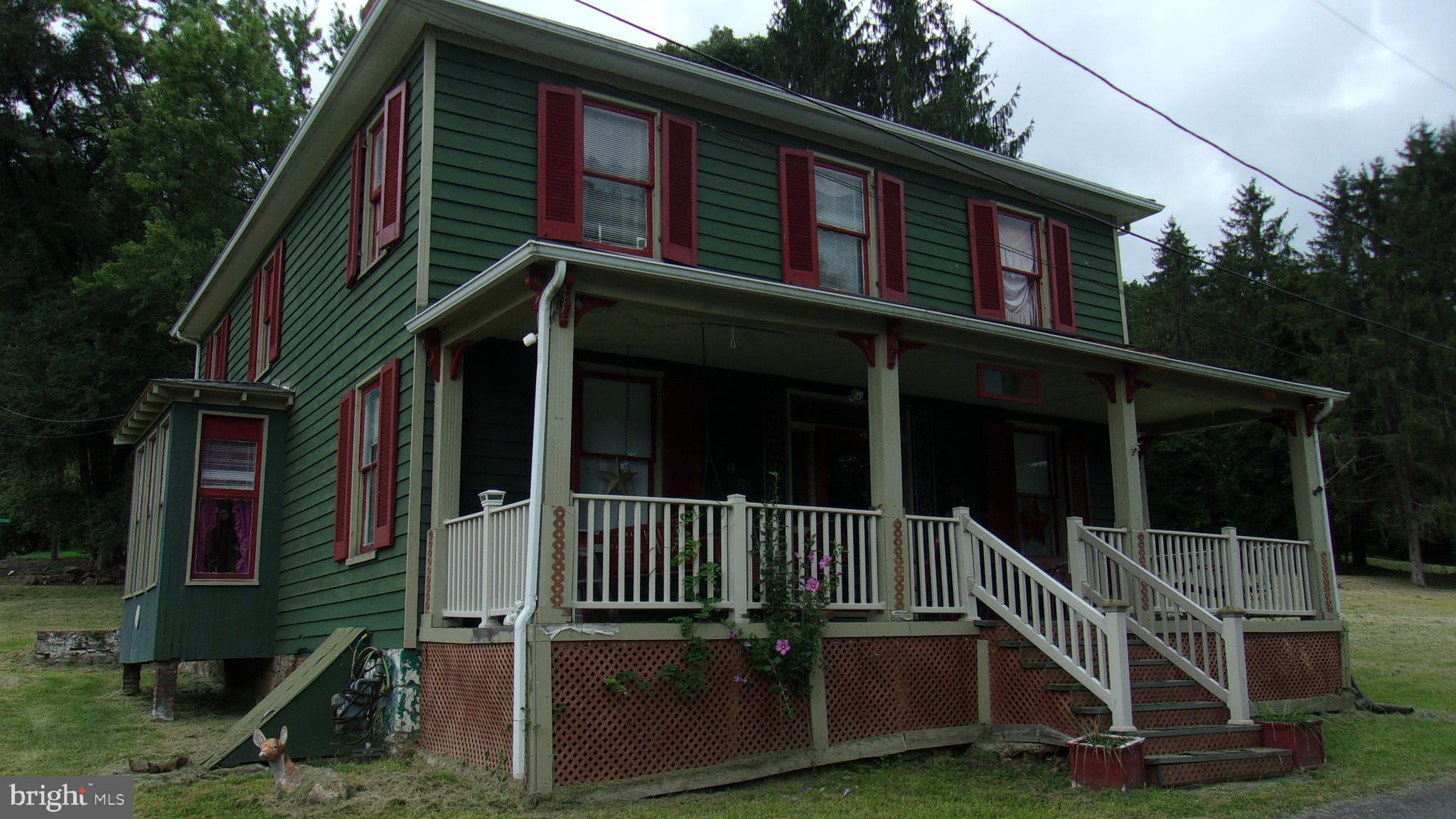 108 Knight Street Bloomington, MD 21523 - Photo 3 of 31 a view of a house with a yard and deck