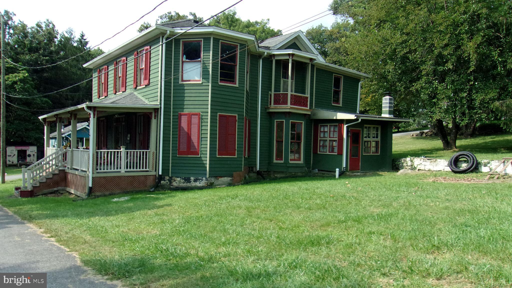 108 Knight Street Bloomington, MD 21523 - Photo 4 of 31 a front view of a house with garden