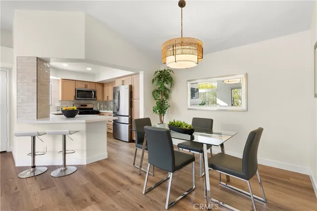 a view of a dining room with furniture wooden floor and chandelier