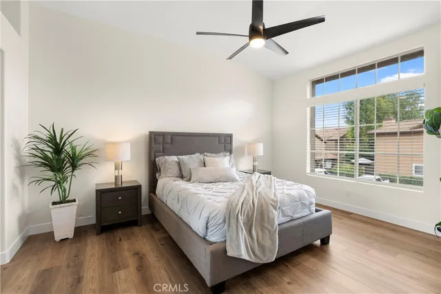 a bedroom with a large bed and a potted plant