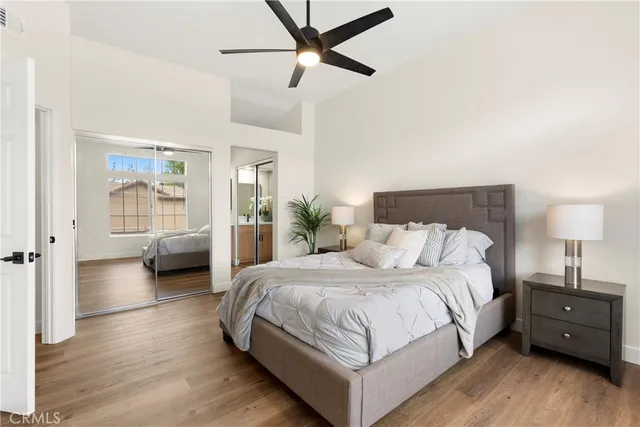 a bedroom with a bed and a chandelier