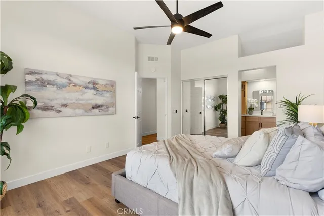 a bedroom with a bed and a painting on the wall