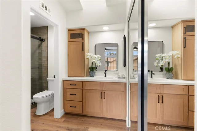 a spacious bathroom with a granite countertop sink and a mirror