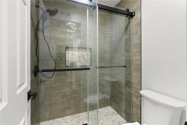 a bathroom with a glass shower door
