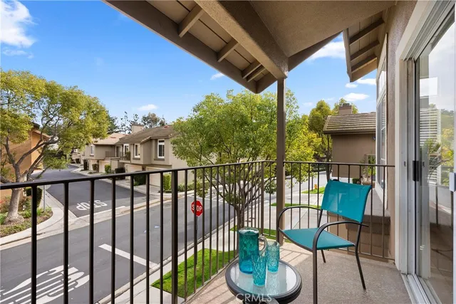 a view of a chairs and table in the balcony