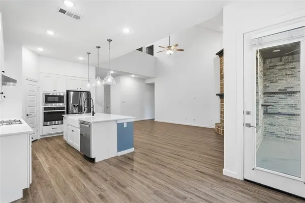 a view of kitchen with sink microwave and refrigerator