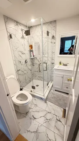 a bathroom with a sink toilet and shower