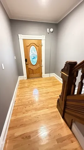 a bedroom with a bed and a wooden floor