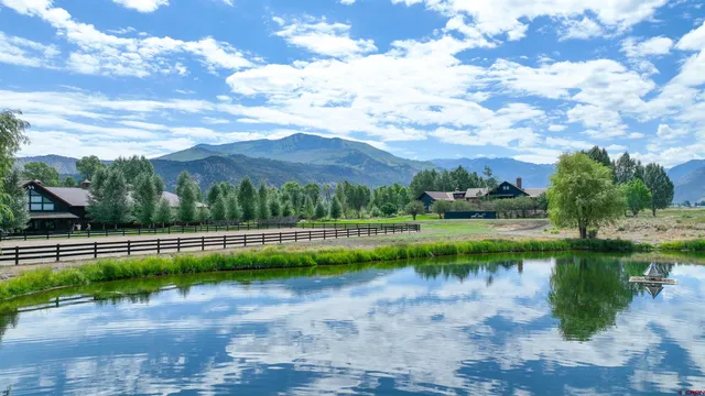 a view of a lake with a house in the background