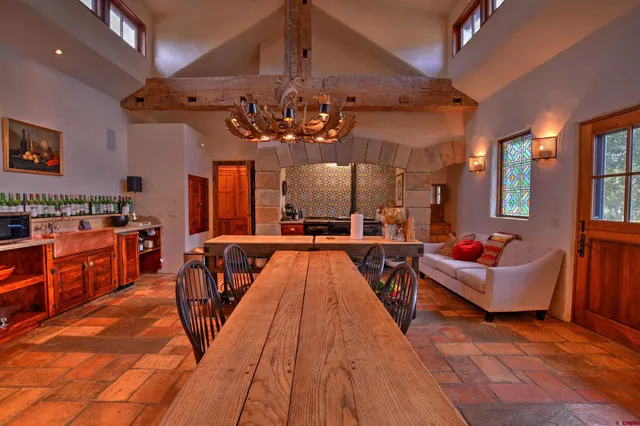a living room with lots of furniture and kitchen view