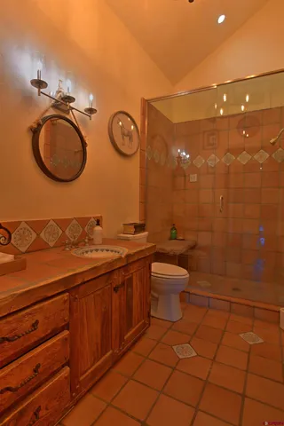 a bathroom with a sink mirror vanity and toilet