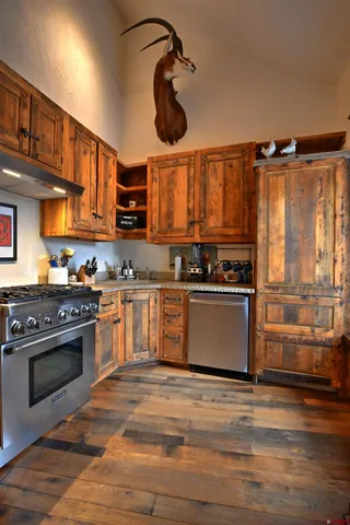 a kitchen with stainless steel appliances granite countertop a stove and a sink