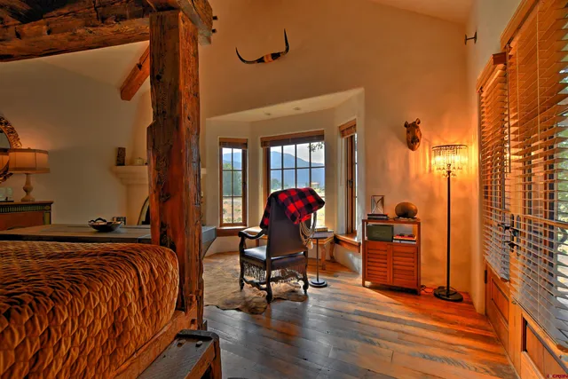 a living room with furniture a ceiling fan and a window