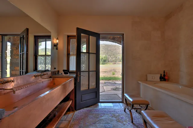 a room with pool table and two mirrors