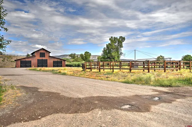 a view of house with outdoor space and lake view