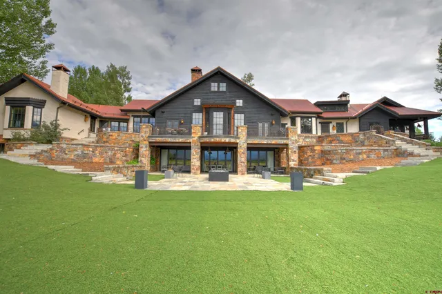 a front view of a house with a garden and yard