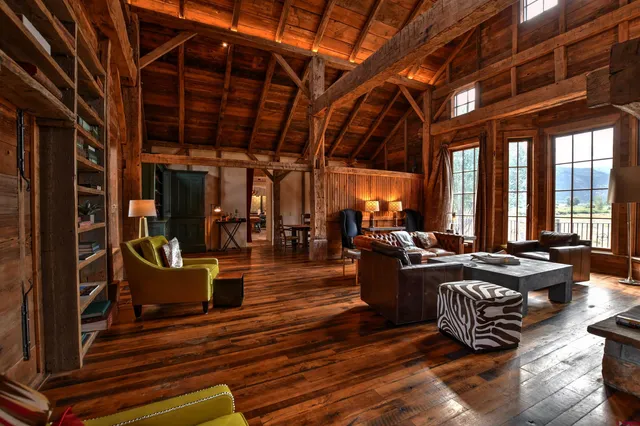 a living room with fireplace furniture and a large window