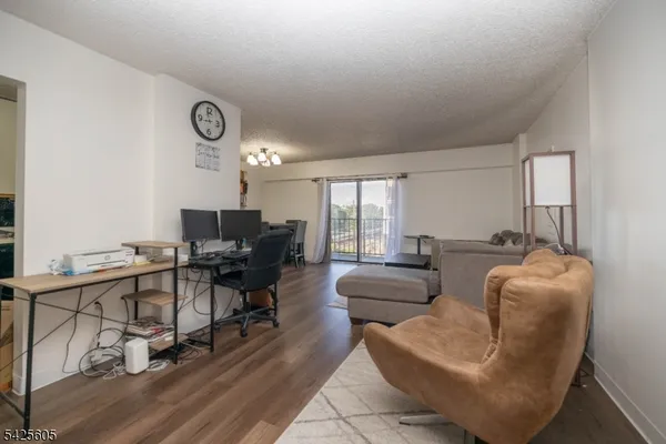 a view of a livingroom with workspace and a couch