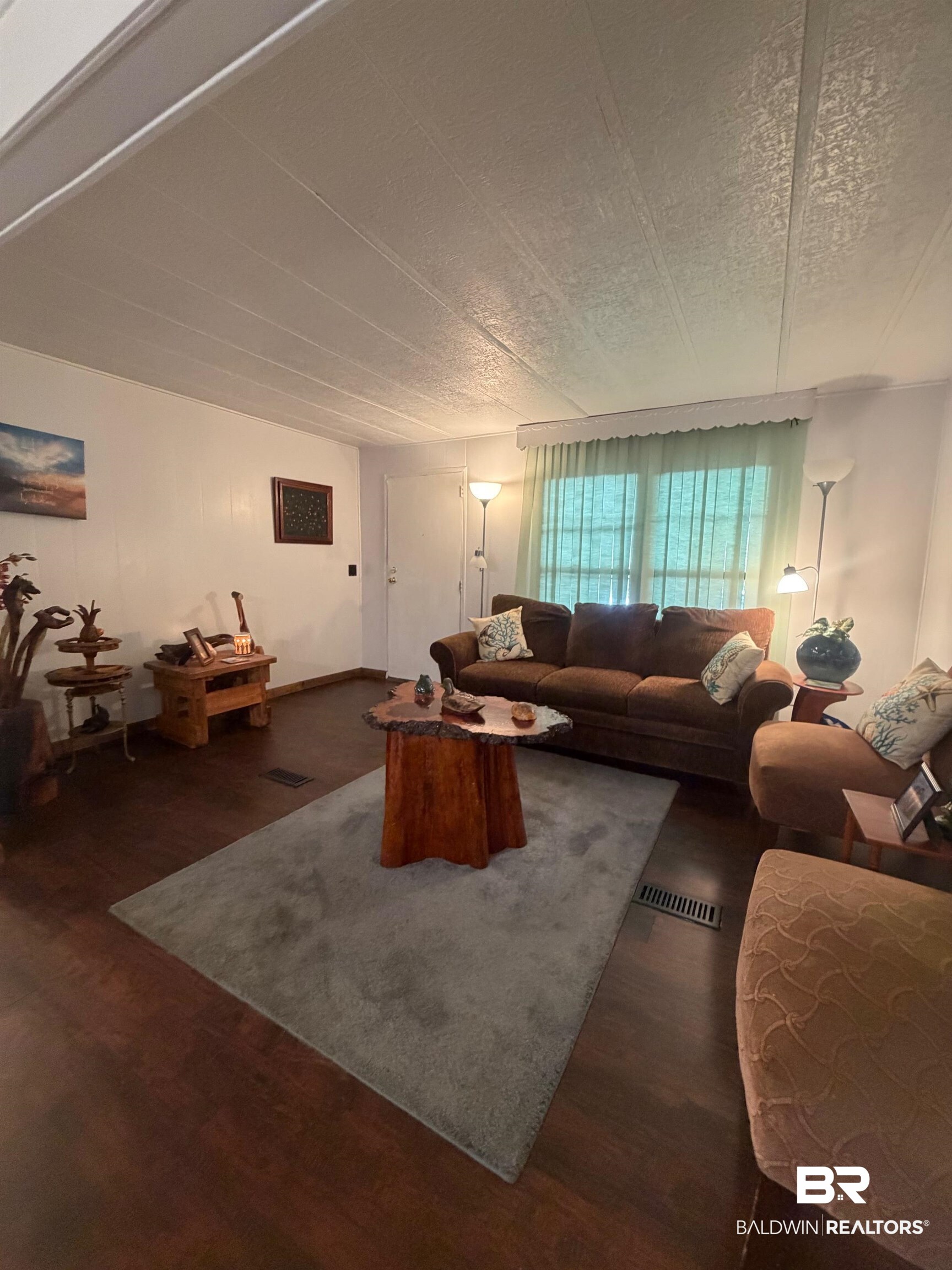 1430 Ridgewood Drive Lillian, AL 36549 - Photo 5 of 34 Living area with dark wood-type flooring and a textured ceiling