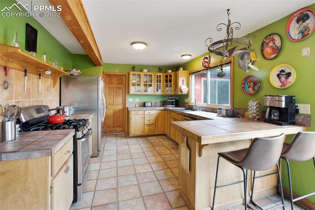 12 Ridge Drive Divide, CO 80814 - Photo 14 of 49 a kitchen that has a lot of cabinets in it and appliances