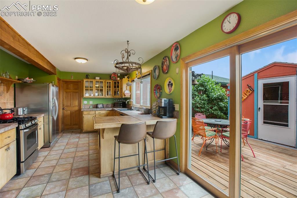 12 Ridge Drive Divide, CO 80814 - Photo 15 of 49 a kitchen with a stove a sink and a refrigerator