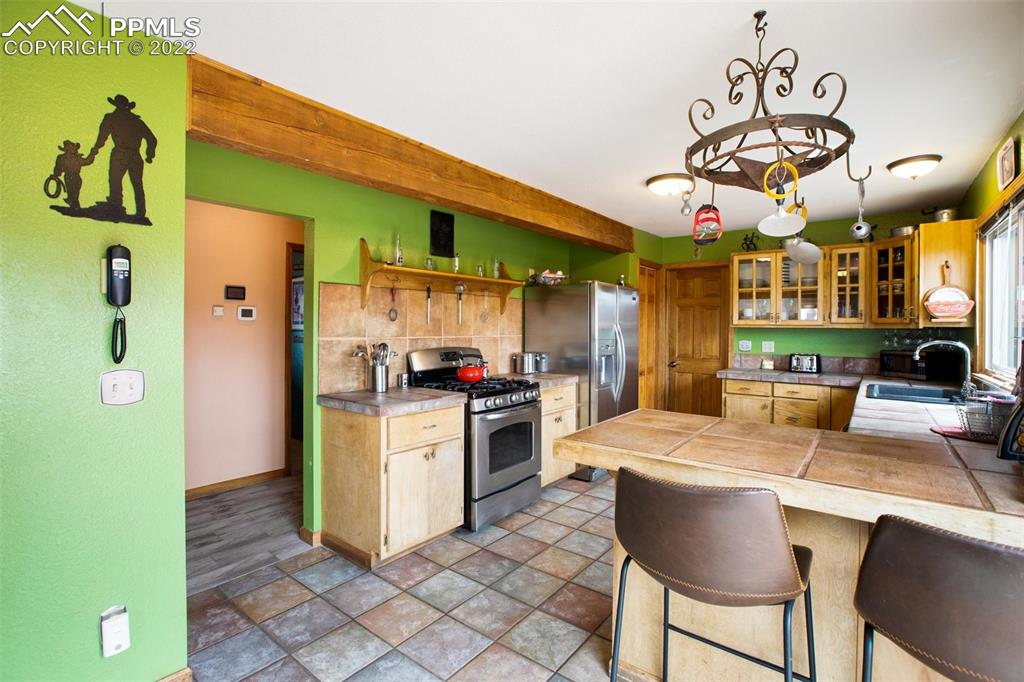 12 Ridge Drive Divide, CO 80814 - Photo 16 of 49 a kitchen with stainless steel appliances granite countertop a refrigerator a stove top oven a sink and dishwasher