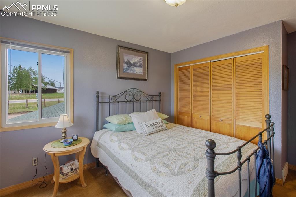 12 Ridge Drive Divide, CO 80814 - Photo 28 of 49 a bedroom with a bed and a table in it