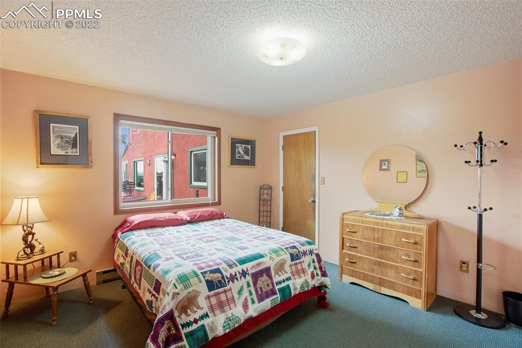 12 Ridge Drive Divide, CO 80814 - Photo 35 of 49 a bedroom with a bed a dresser and window
