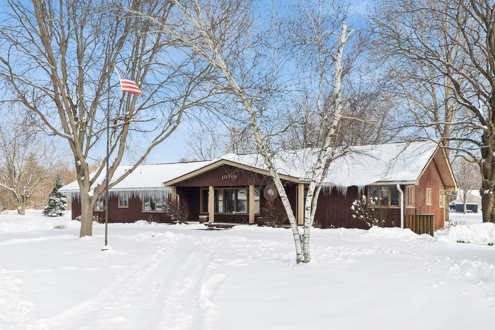 a view of house with a yard covered in snow