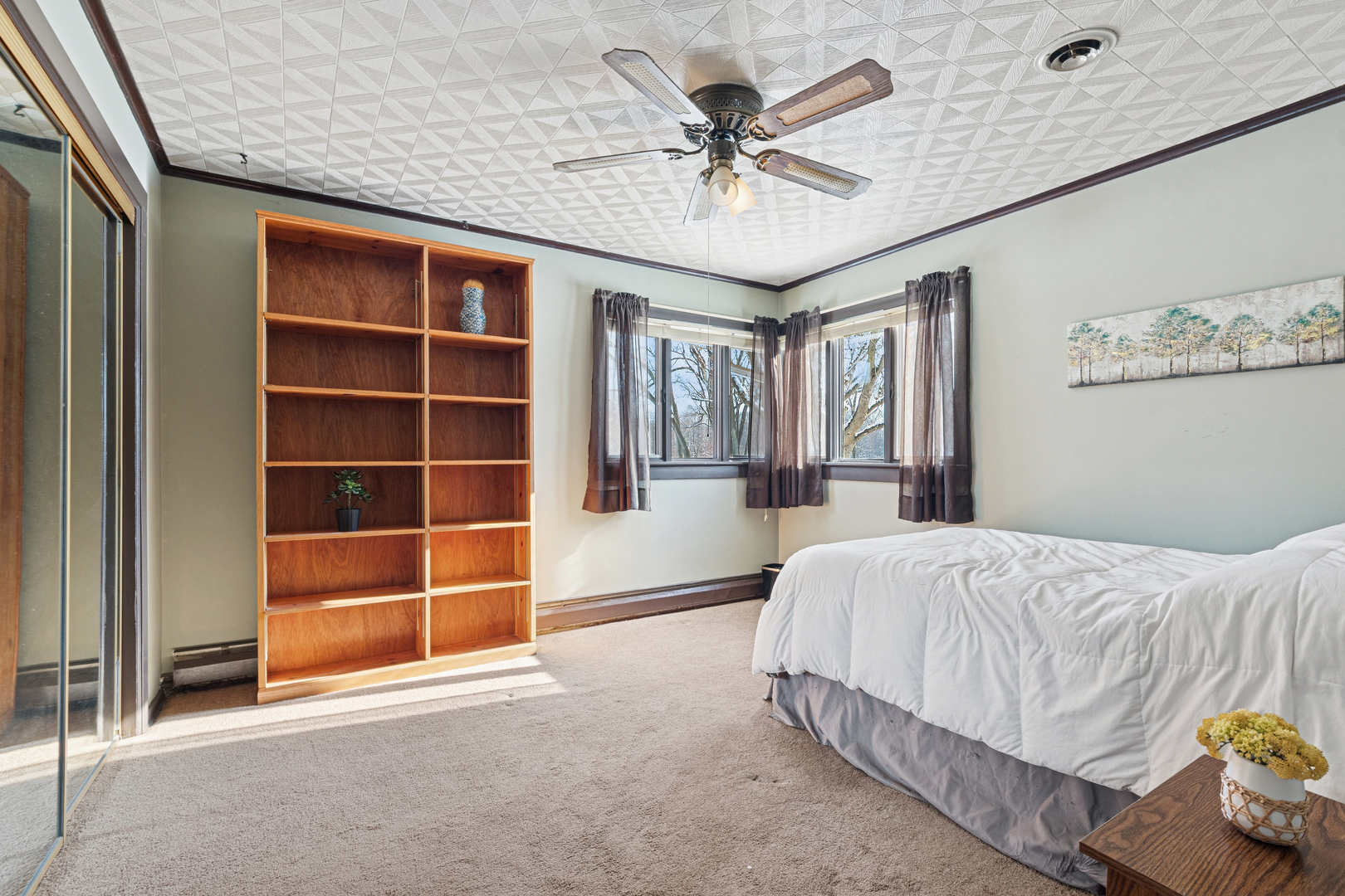 10705 Lane Street Crown Point, IN 46307 - Photo 17 of 36 a spacious bedroom with a bed and a chandelier