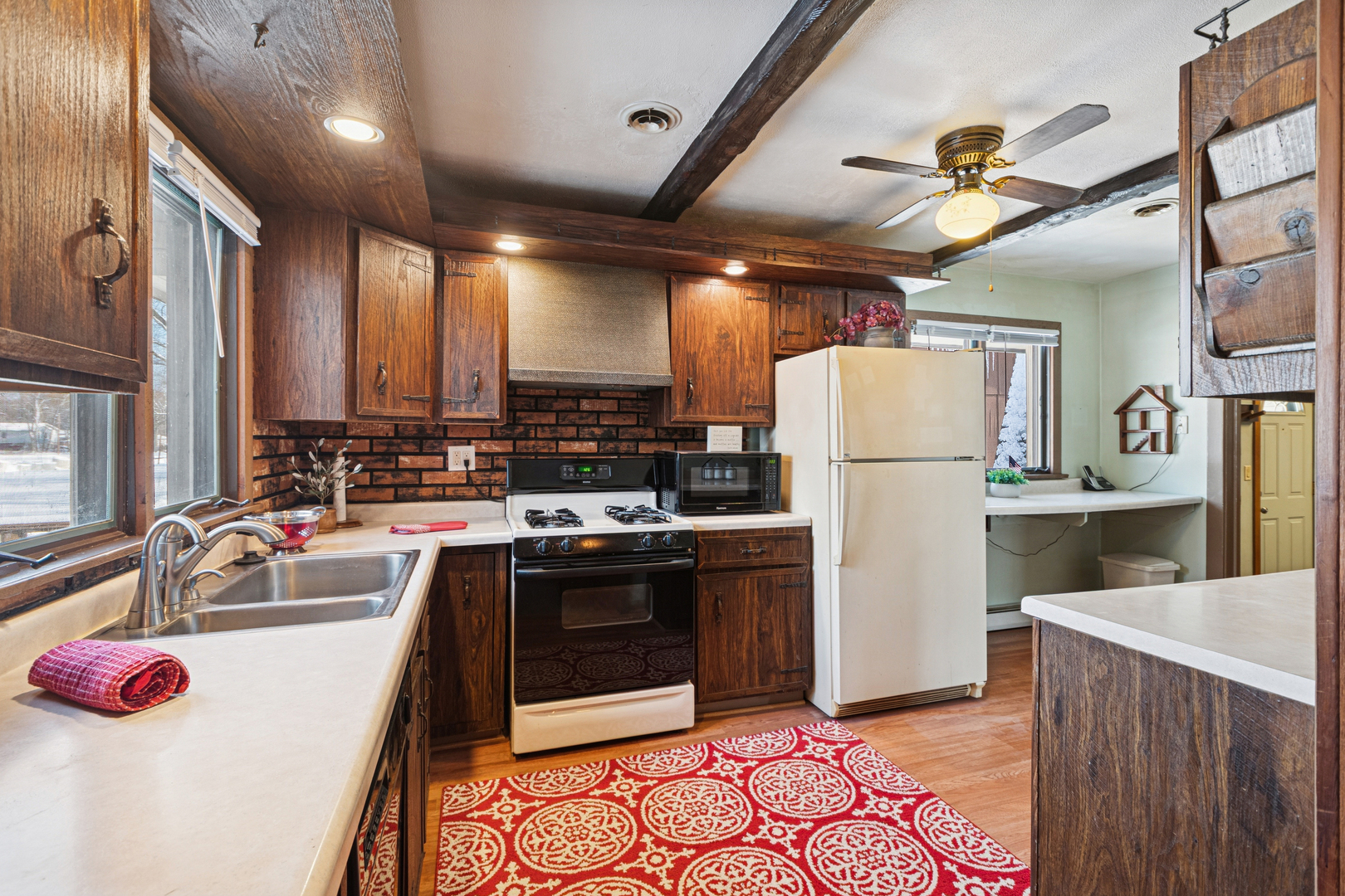 10705 Lane Street Crown Point, IN 46307 - Photo 6 of 36 a kitchen with refrigerator sink and stove