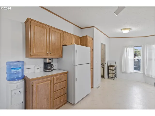 a kitchen with a refrigerator a sink and cabinets